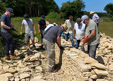 Group building a dry stone wall
